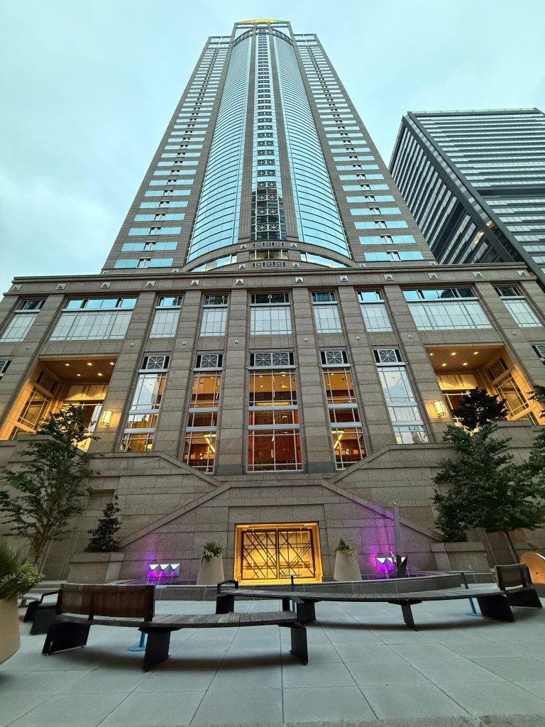 View of a modern skyscraper in Seattle, showcasing its vertical architecture against a cloudy sky.