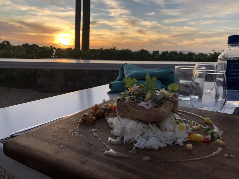 A dinner plate with a view of the Fiji sunset